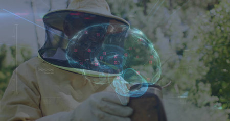 Examining wooden hive frame beekeeper wearing suit and mesh veil in garden. Outdoor, nature, health, educationの写真素材