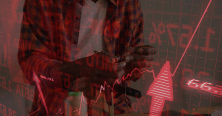 Man wearing red flannel shirt tapping smartphone with stylus in tech office, with red grid overlay. Technology, finance, data, analytics, digital, innovation, investmentの写真素材