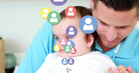 Cradling male holding baby on sofa in bright living room. Family, bonding, domestic, tender,...