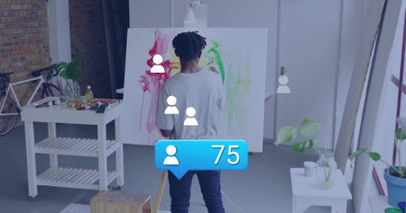 Painting artist applying red yellow strokes on canvas in art studio loft, with easel and bicycle. Creative, innovation, craftsmanship, modern, inspirational, workspace, colorfulの写真素材