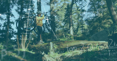 Balancing cyclist shouldering mountain bike on forest trail, with helmet backpack. Adventure, exploration, nature, wilderness, fitness, outdoorの写真素材