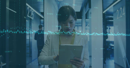 Interacting businesswoman tapping tablet in corporate hallway, with data overlay and numbered doors....