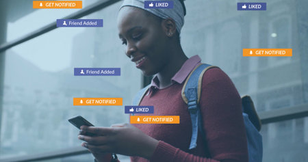 Smiling student holding smartphone in transit station, with floating notifications, copy space....