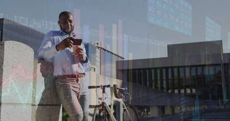 Leaning man tapping smartphone, holding coffee cup beside bicycle on barrier at plaza, copy space. Urban, professional, modern, casual, business, technology, lifestyleの写真素材