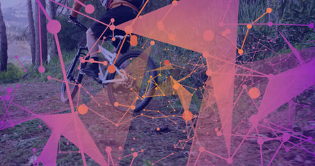 Male cyclist wearing helmet and jersey pedaling mountain bike on dirt trail, with network shapes. Adventure, fitness, technology, innovation, outdoor, dynamic, activewearの写真素材