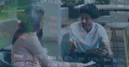 Colleagues discussing stocks in office, with tablet, table and chairs, glass partition and tickers. Business, technology, innovation, finance, investment, corporate, collaborationの写真素材