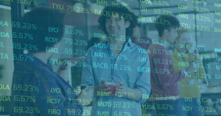 Chatting coworkers holding red coffee mug, smartphone and laptop in modern office lounge area. Collaboration, networking, professional, modern, innovative, casual, workspaceの写真素材