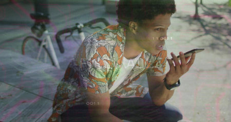 Holding smartphone man wearing floral shirt crouching on plaza with bicycle, smartwatch, overlays....