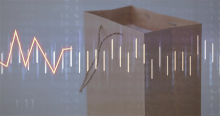 Displaying brown paper shopping bag with financial charts overlay in studio, data visualization....