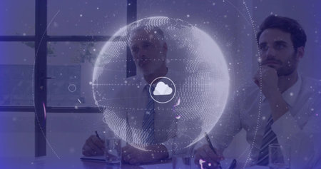 Two colleagues studying floating holographic globe with cloud icon in conference room, holding pens....