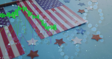 Displaying two American flags flanking candlestick charts on blue surface, with star confetti....