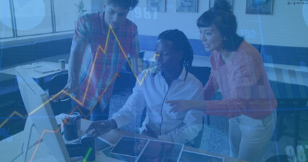 Collaborating office colleagues analyzing design mockups at office desk, with computer and tablet. Collaboration, teamwork, modern workspace, creative process, professional environment, innovation, productivityの写真素材