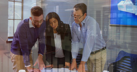 Analyzing team reviewing printed reports and discussing data at conference table, chart overlay. Corporate, teamwork, innovation, presentation, analytics, modernity, productivityの写真素材