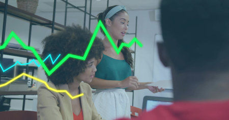 Woman in green tank top holding document in office with laptop, line graphs, copy space. Collaboration, teamwork, innovation, productivity, professional, modern, analyticsの写真素材