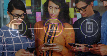 Tapping smartphones coworkers connecting in office, with sticky notes on glass and network icons. Collaboration, teamwork, innovation, connectivity, workspace, modernity, communicationの写真素材