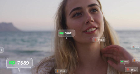 Standing female wearing crochet top gazing at sunset beach, with digital comment and heart icons....