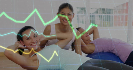Three women doing abs workout in gym studio, with colored mats, stability ball, translucent overlay. Fitness, wellness, teamwork, vitality, strength, health, trainingの写真素材