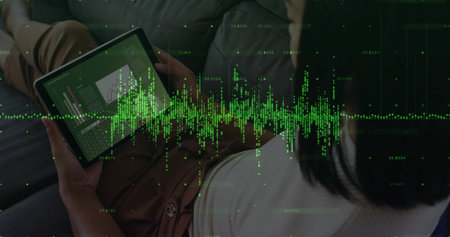 Leaning woman wearing business casual viewing charts with tablet on sofa at home with green overlay....