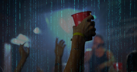 Raising attendee arm holding red plastic cup at club, with smartphone stage lights haze. Nightlife, celebration, energy, party, vibrant, entertainment, crowdの写真素材