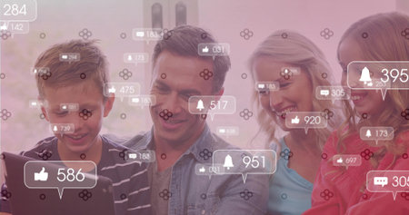 Sitting family interacting with tablet and smartphone on sofa in living room, notification icons. Technology, communication, relaxation, modern, domestic, connectivity, leisureの写真素材