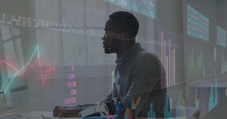 Typing male analyst analyzing transparent market charts on monitor at office desk, with keyboard. Technology, finance, data, analytics, modern, workspace, professionalの写真素材