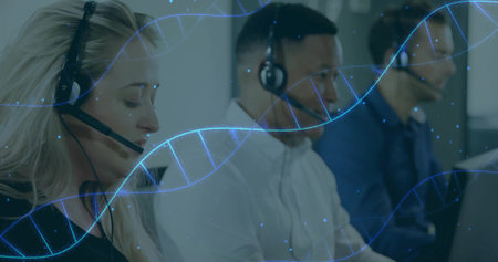 Handling calls three agents working at desks in open-plan office, with headsets. Collaboration,...