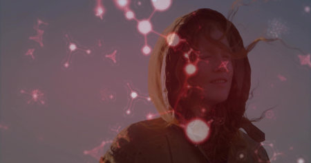 Standing woman in hooded jacket facing right against dusk sky, showing molecular nodes, copy space....