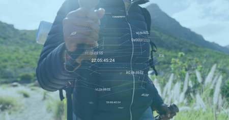 Manipulating floating data hologram, hiker in dark jacket on mountain trail with backpack and poles....