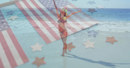 Raising arms woman wearing bikini and snorkel mask at beach, with American flag stripes and stars. Vacation, leisure, aquatic, refreshing, patriotic, adventure, summerの写真素材