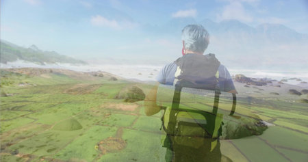 Standing hiker wearing backpack with rolled mat, surveying algae shoreline and ocean waves. Adventure, exploration, nature, tranquility, wilderness, scenic, ruggedの写真素材