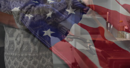 Couple cooking with frying pans on lit stovetop in home kitchen, with blue oven, oil bottle. Patio, intimacy, culinary, homely, vibrant, arrangement, familyの写真素材