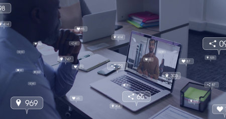 shirted man joining virtual meeting at desk, with main laptop smartphone floating icons, copy space....