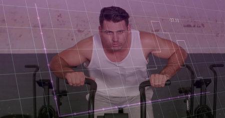 Man wearing white tank top, gray shorts pushing air bike pedals at gym, with data overlay. Fitness, endurance, conditioning, innovation, technology, strength, motivationの写真素材