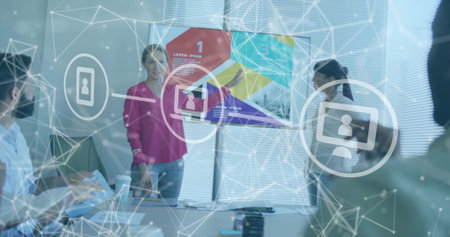 Presenting businesswoman pointing at wall-mounted display in meeting room, with network infographic. Collaboration, teamwork, professional, corporate, network, digital, modernの写真素材