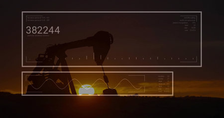 Pumping oil pump jack silhouette extracting crude at sunset on flat plain, with data overlays. Industrial, technology, analytics, data visualization, energy, machinery, duskの写真素材