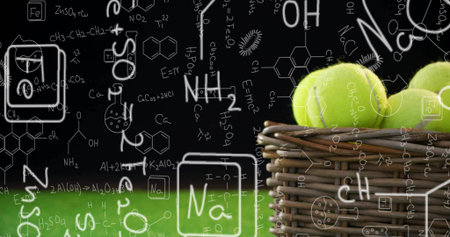 Displaying wicker basket containing yellow tennis balls on grass, backdrop of formulas, copy space. Sports, science, innovation, education, laboratory, experimental, dynamicの写真素材