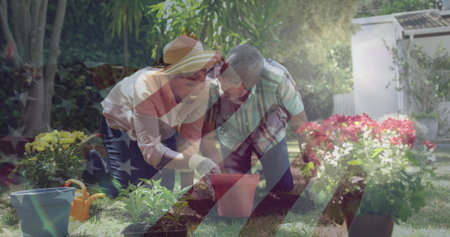 Kneeling senior man and adult woman wearing straw hat planting seedlings into clay pot in backyard. Gardening, horticulture, nature, outdoor, family, ecological, rusticの写真素材
