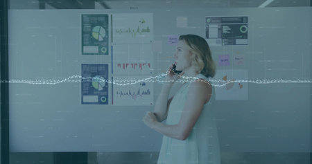 Discussing data woman holding smartphone near board with sticky notes in meeting room, copy space....
