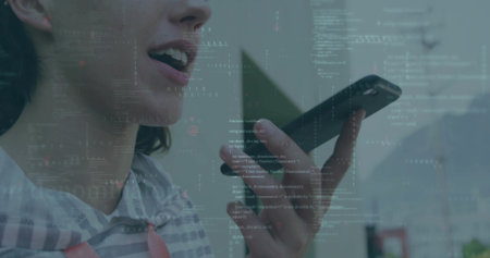 Speaking coder in striped sweatshirt holding phone at mouth in room, with code overlay, copy space....