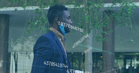 Standing executive wearing navy suit, surgical mask lowered in plaza with data overlay, copy space. Corporate, modern, sleek, professional, technology, urban, innovationの写真素材