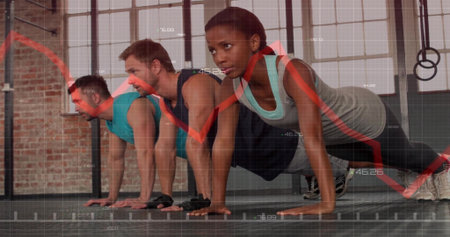 Trio wearing sportswear performing push-ups on mats in brick gym, with boxes rings graph overlay....