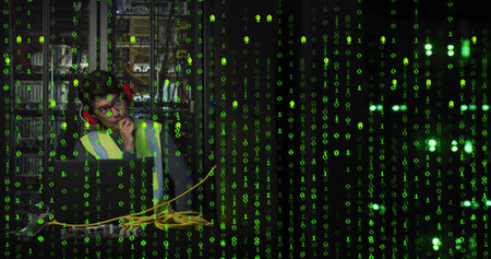 Using laptop with cables in server room under green overlay wearing vest and protectors, copy space....
