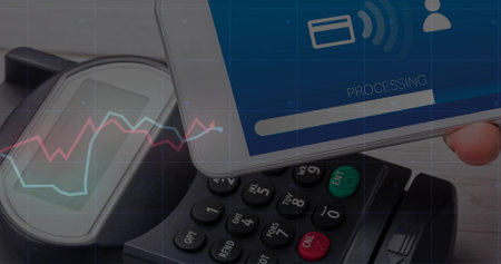 Processing payment on smartphone on wooden countertop, showing POS terminal, line graph, copy space....