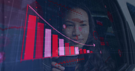 Asian woman in blazer using transparent touchscreen in office displaying falling magenta bar chart. Futuristic, innovation, analytics, technology, data visualization, professional, sleekの写真素材
