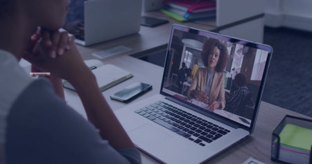 Joining remote meeting, coworker sitting at office desk, with laptop smartphone notebook pen holder. Collaboration, coworking, communication, modern, productivity, professional, technologyの写真素材