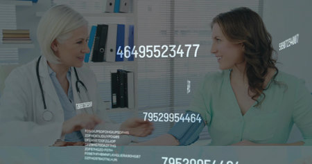 Doctor placing blood pressure cuff on patient arm at clinic desk, with stethoscope draped on neck. Healthcare, medical, professional, diagnosis, monitoring, clinic, wellnessの写真素材