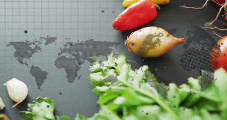 Arranging parsley, garlic cloves, mini peppers and pearl onions on charcoal board with map overlay....