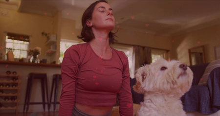 Woman in activewear stretching neck on yoga mat in living room, with fluffy dog, wine rack....