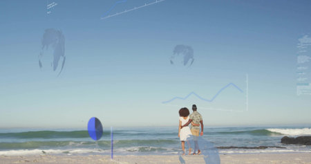 Couple wearing white dress and patterned shirt embracing on sandy beach, with waves. Romantic, leisure, harmony, serenityの写真素材