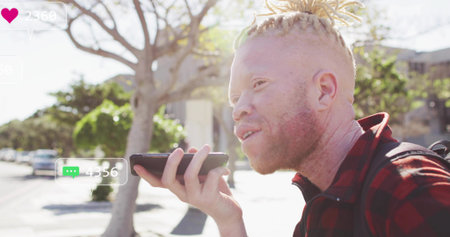 Recording man in plaid shirt speaking into phone with backpack on street, copy space. Urban, lifestyle, vibrant, communication, youth, outdoor, casualの写真素材